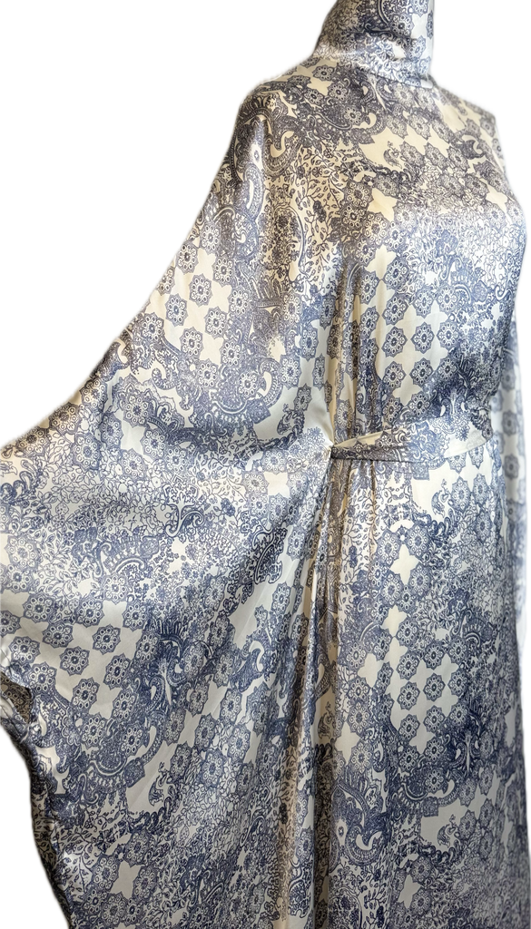 Mannequin wearing a patterned dress with a white background